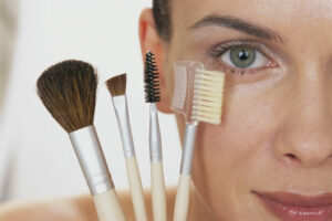 Woman Holding Makeup Brushes
